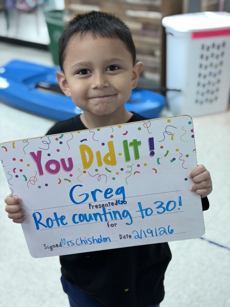 Smiling child holding celebration board