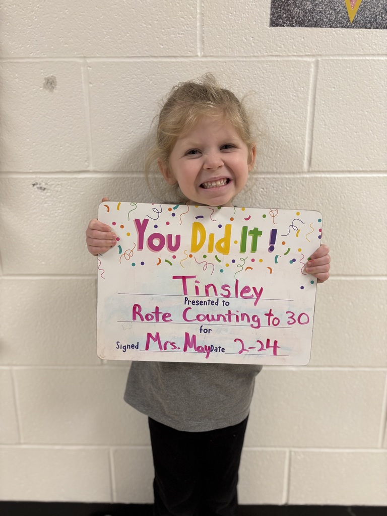 smiling child with celebration board