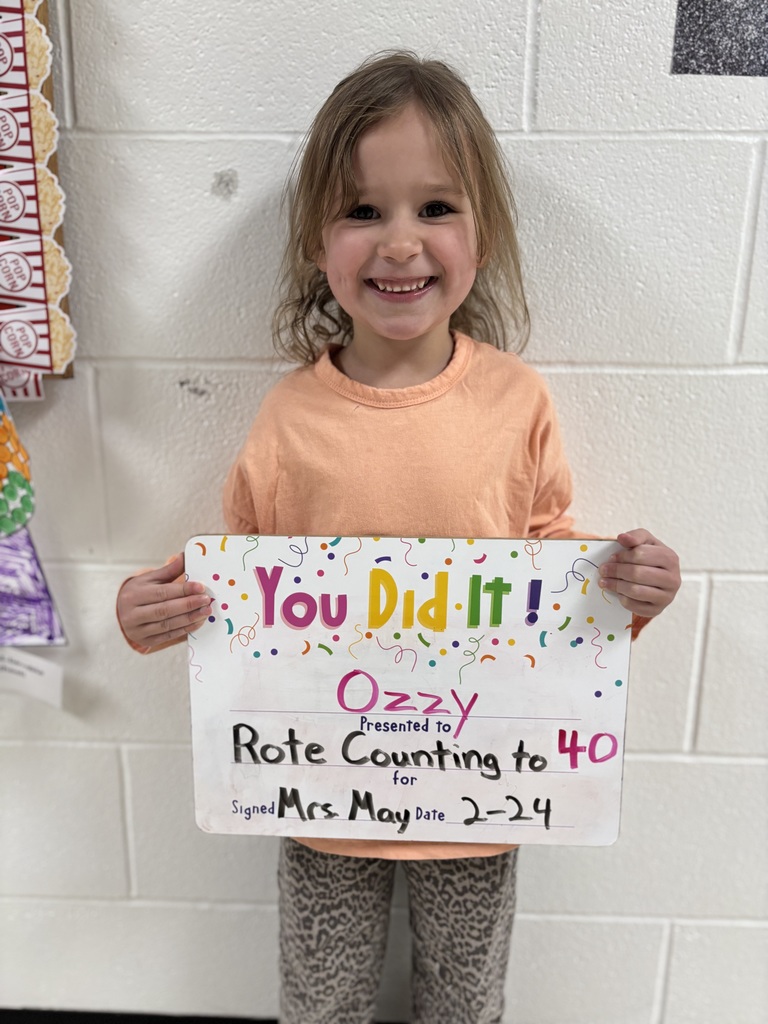 smiling child with celebration board