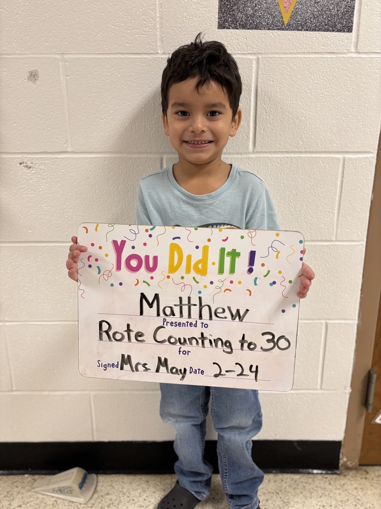 smiling child with celebration board