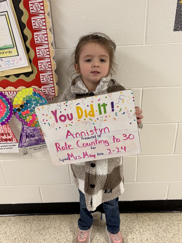 smiling child with celebration board