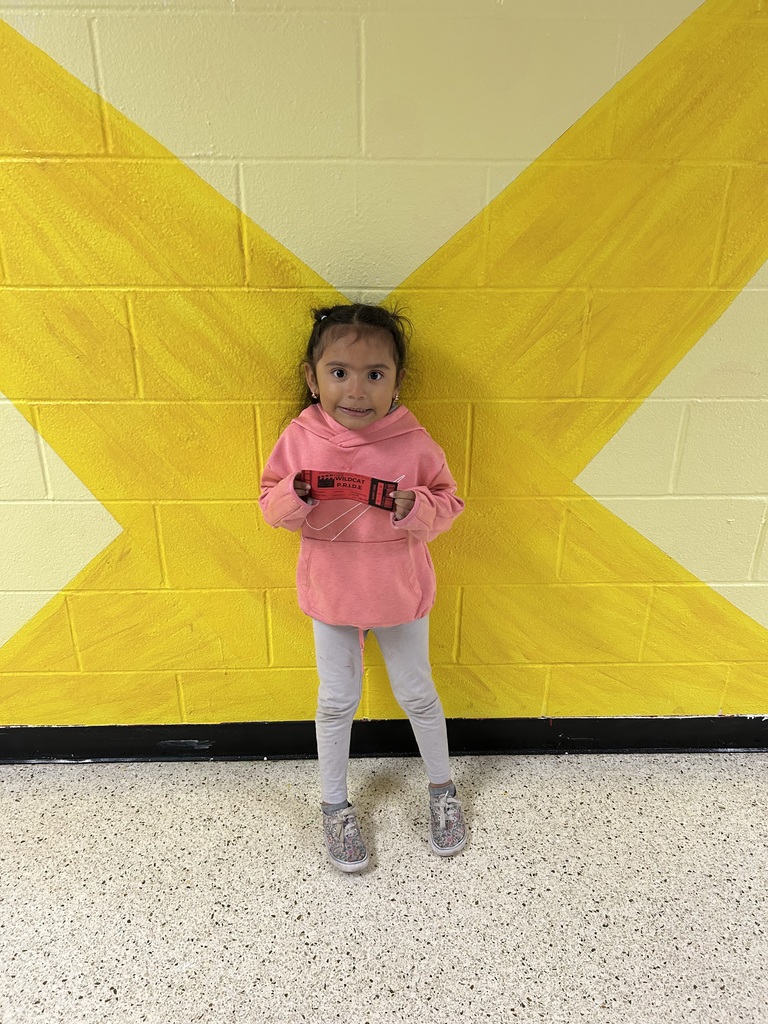 Smiling child holding Wildcat certificate
