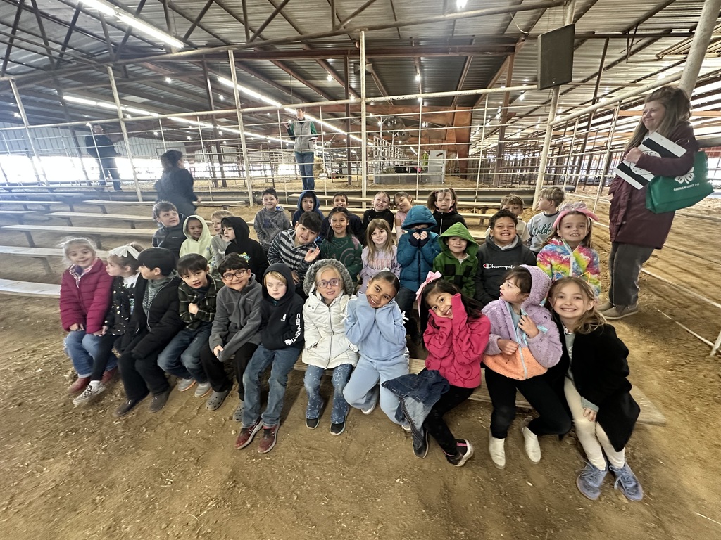 class taking a group photo in the arena
