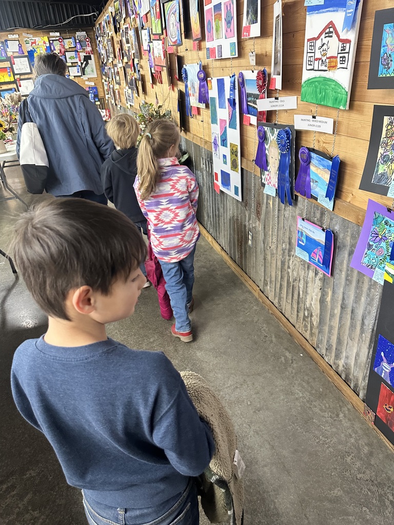 students looking at student art
