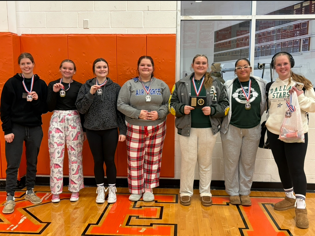 group of 7 teenage girls who medaled in powerlifting competition