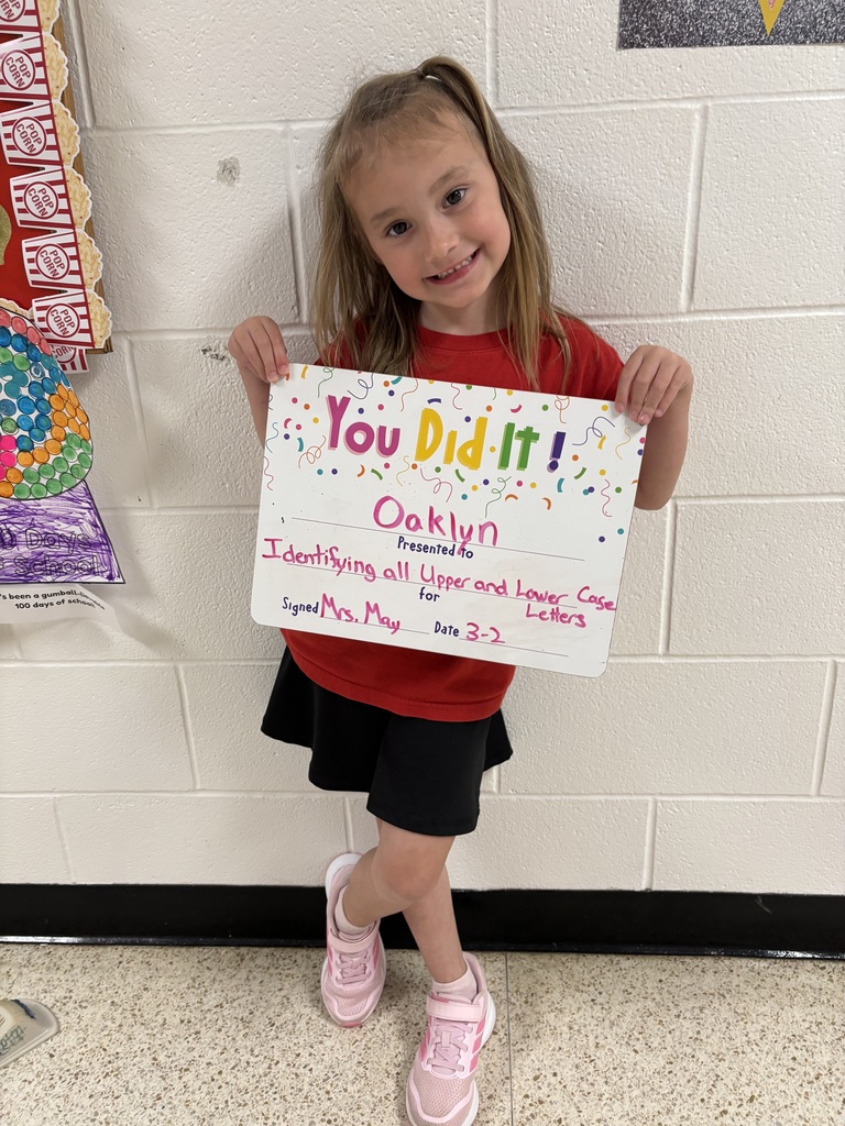 Smiling child holding celebration board