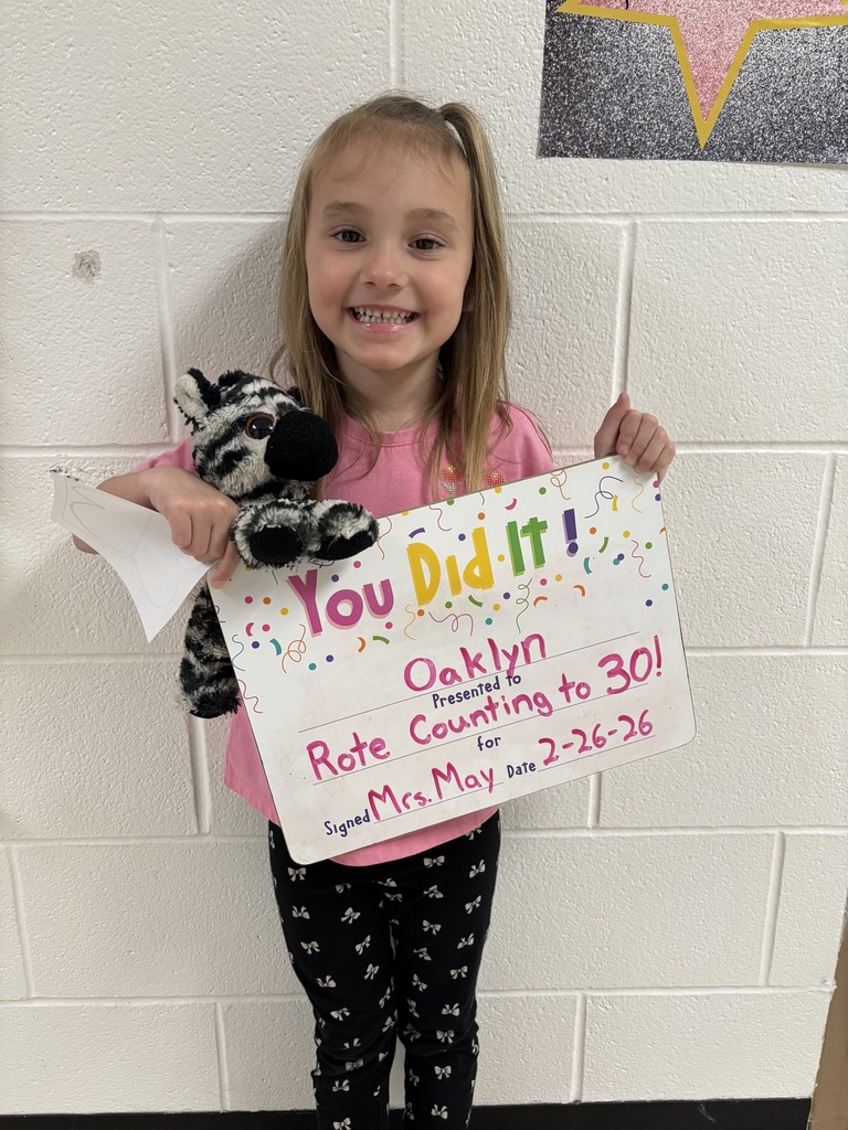 Smiling child holding celebration board