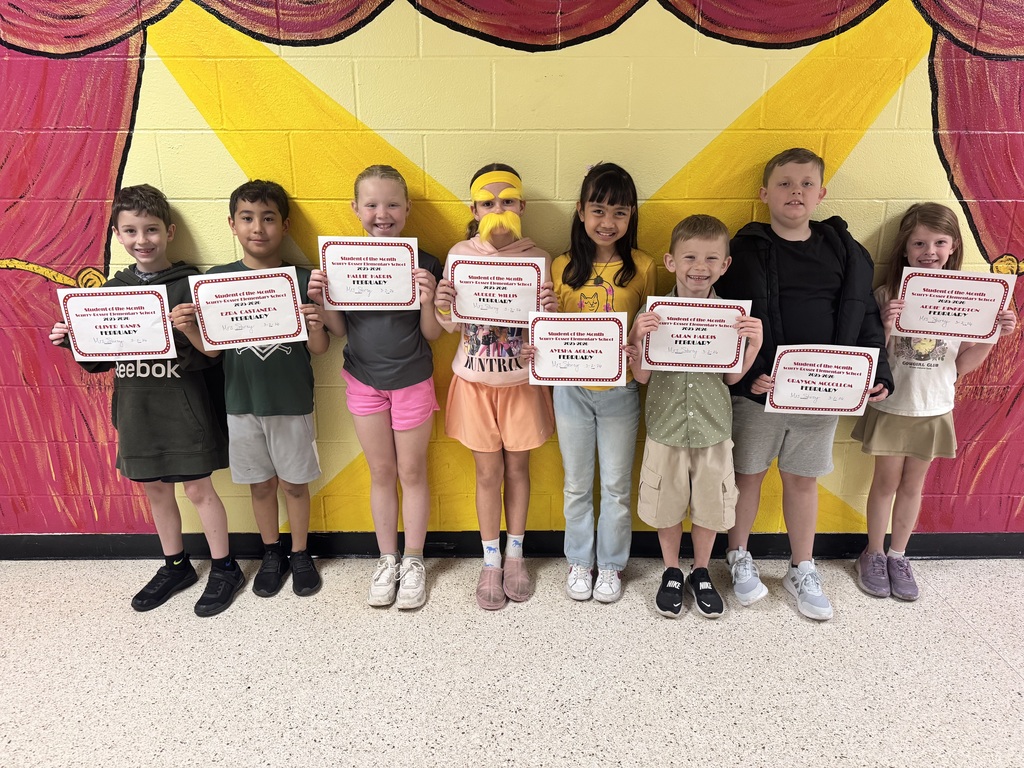 students of the month holding certificates