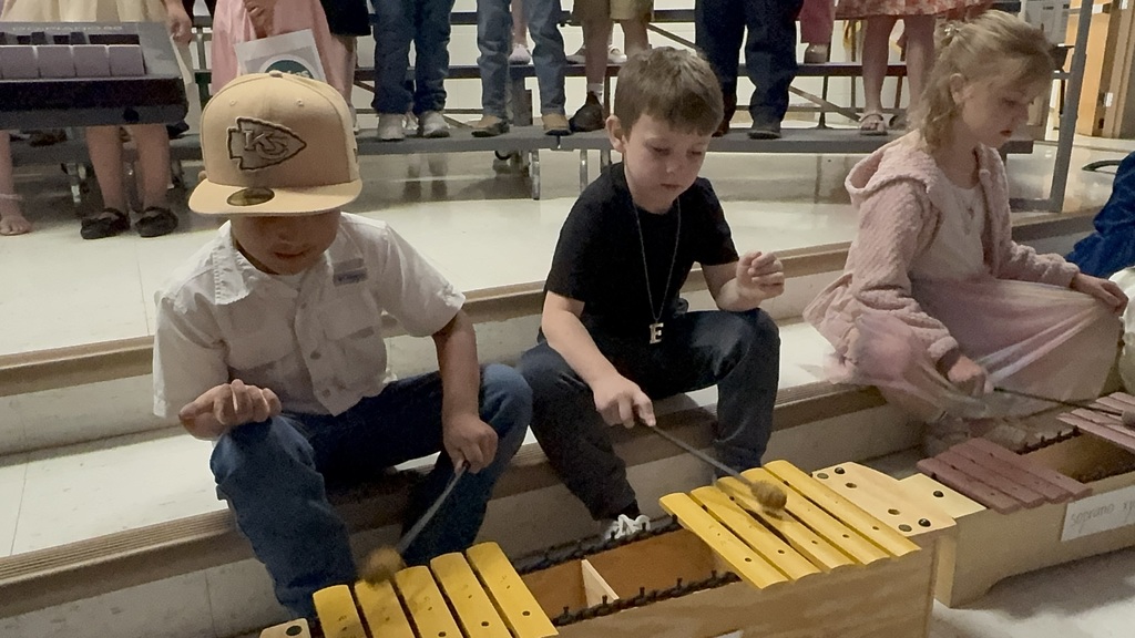male student playing xylophone