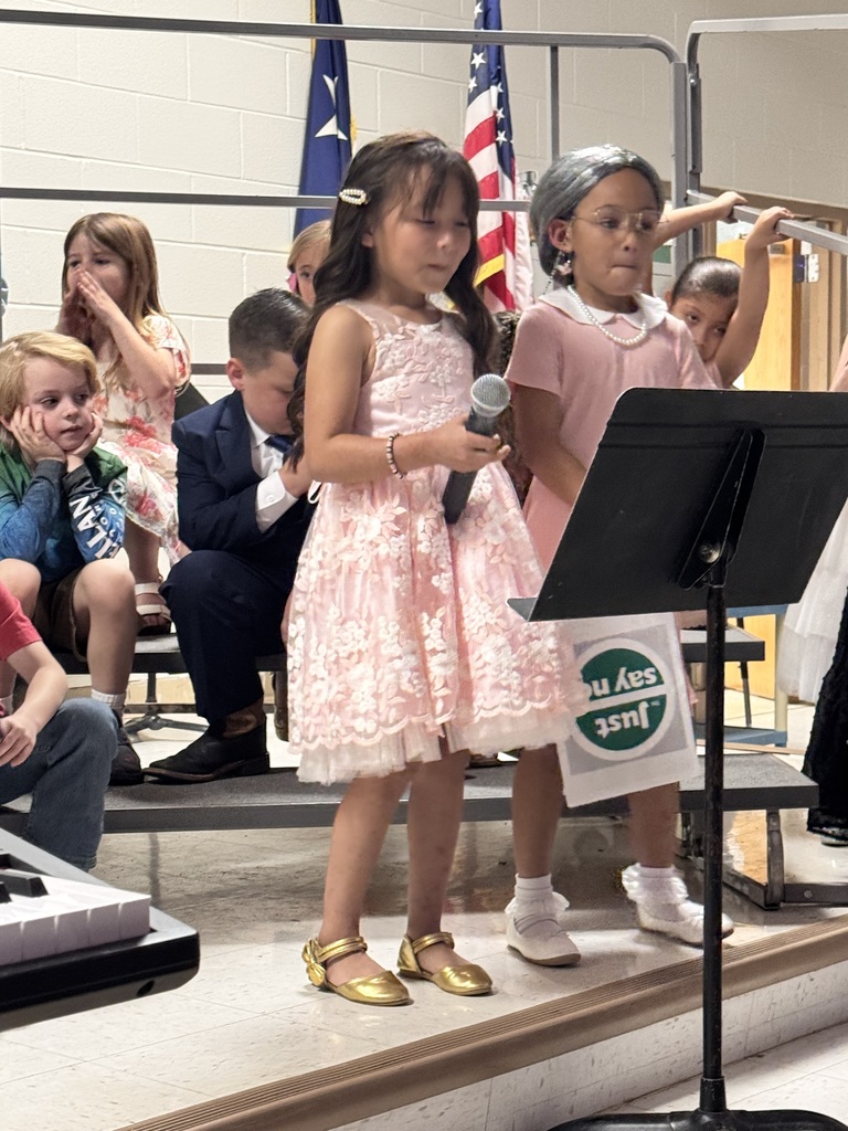 two female 2nd grade students singing