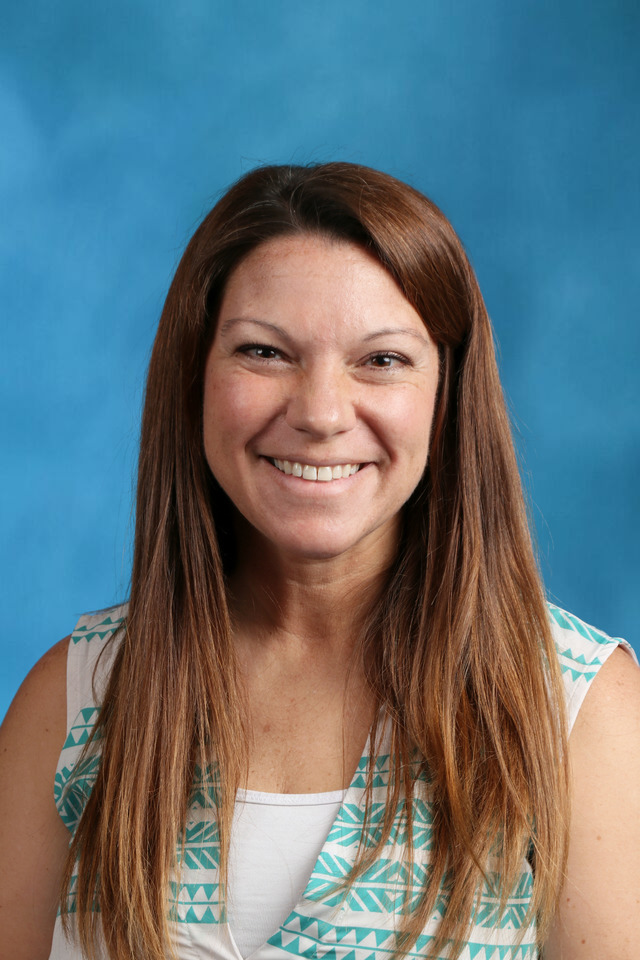 woman with brown hair in a teal and white sleeveless shirt