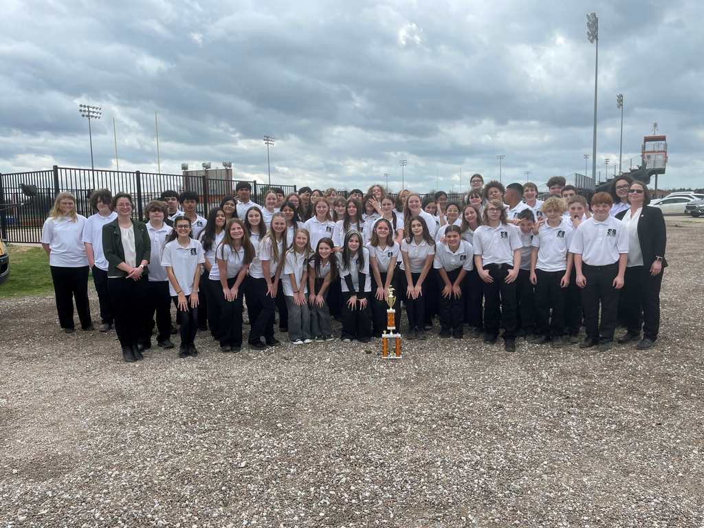 group photo of middle school band students and two sponsors