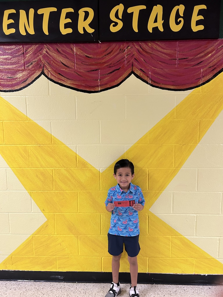 Smiling child holding Wildcat Pride Ticket