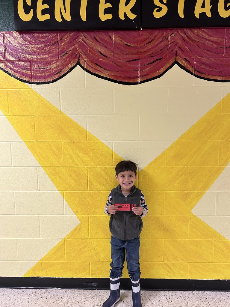 Smiling child holding Wildcat Pride Ticket