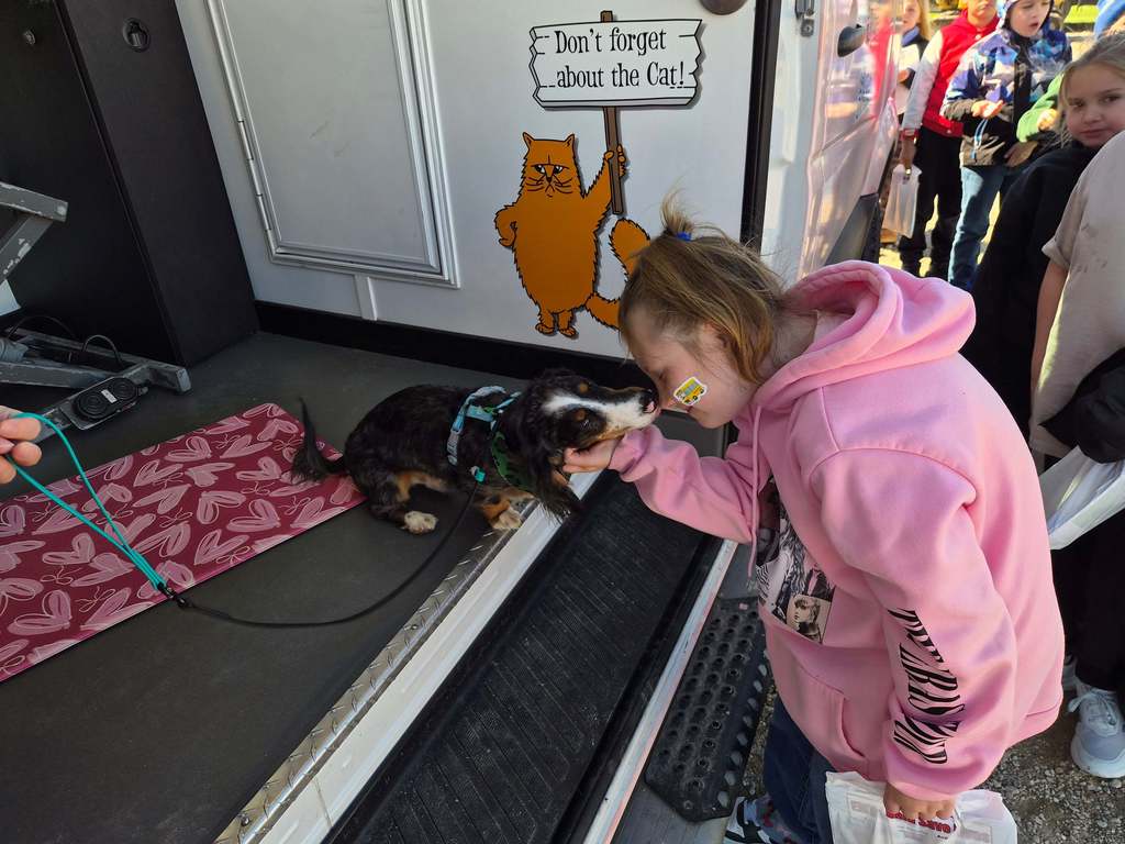 female student petting a dog