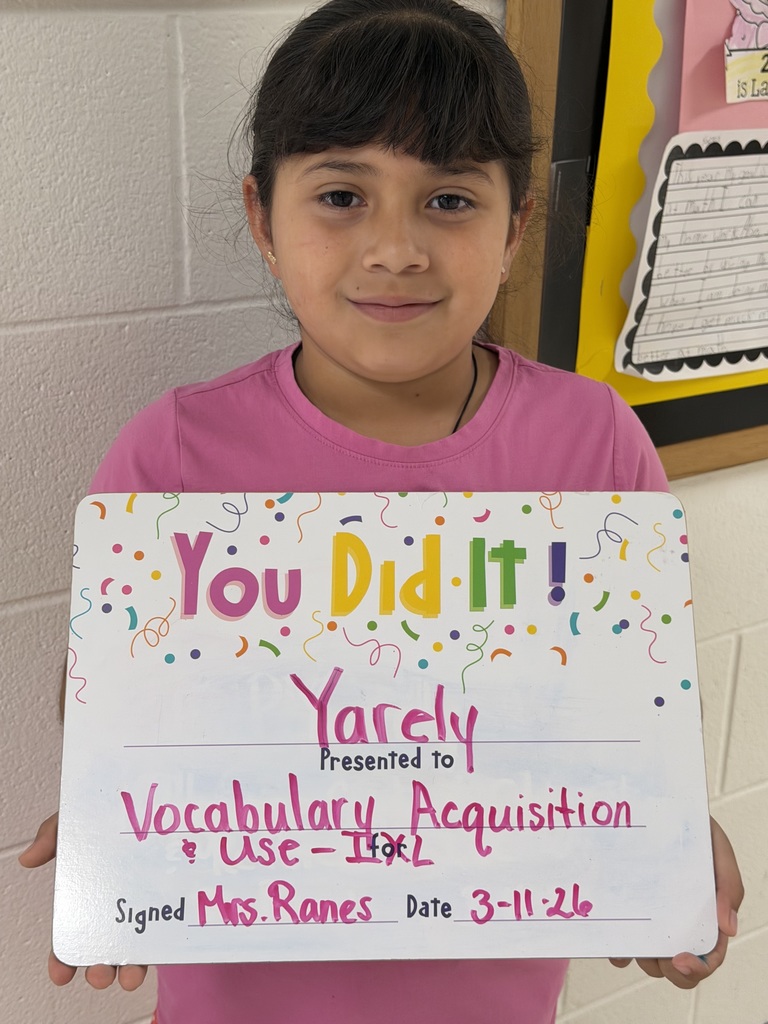 Smiling child holding a celebration board
