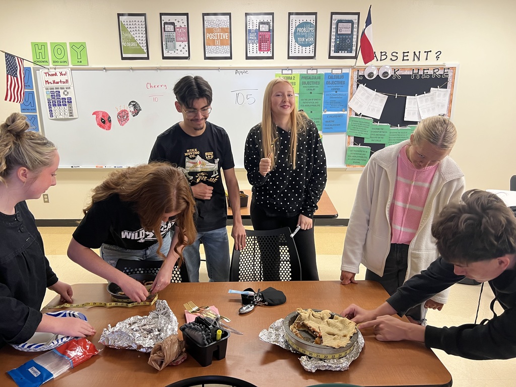 students completing a hands on activity with a measuring tape and pie