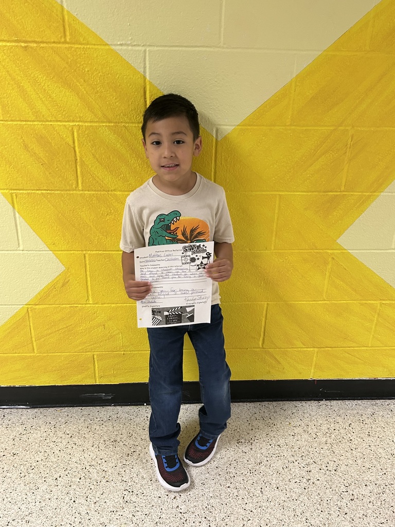 child holding recognition award