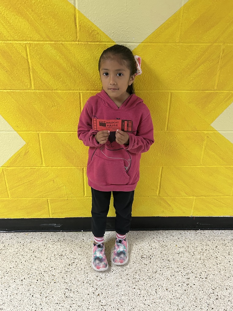 child holding recognition award