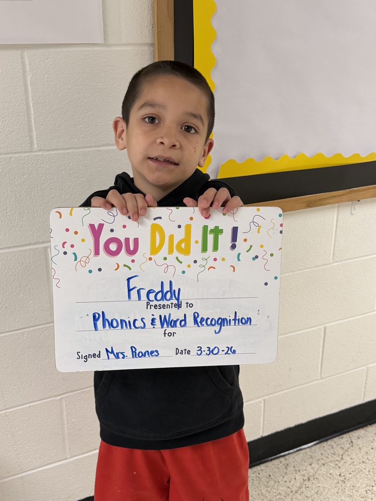 Child holding celebration board.