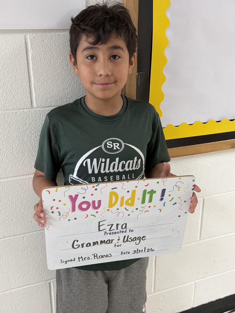 Child holding celebration board.
