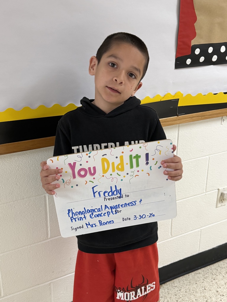 Child holding celebration board.