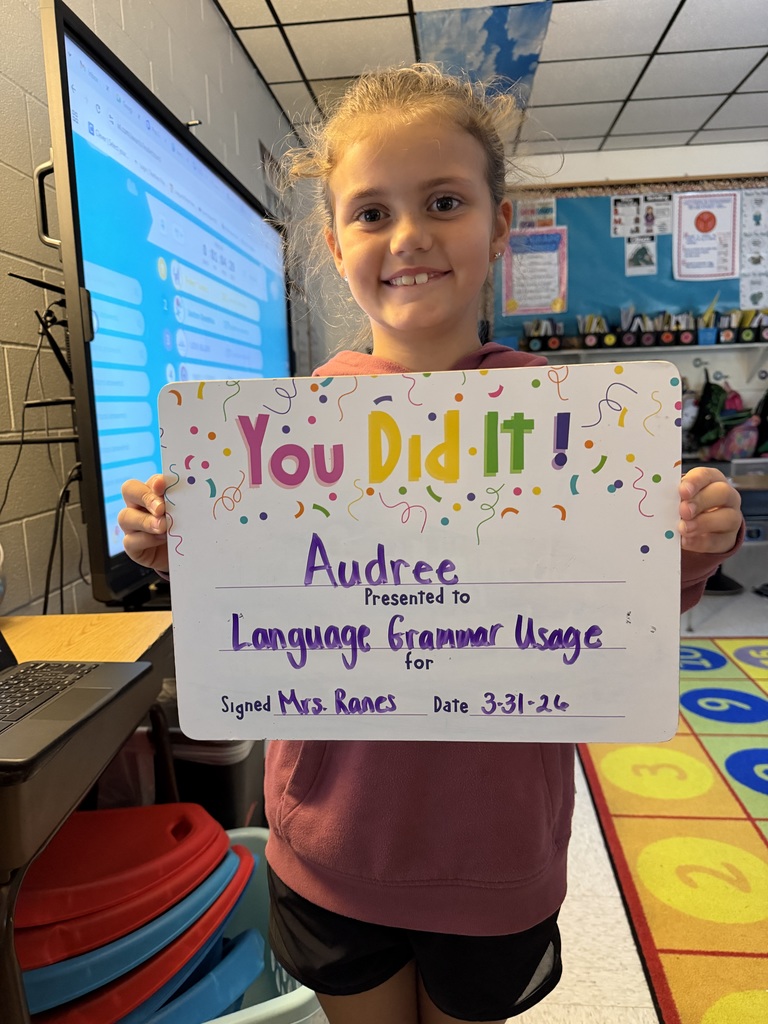Child holding celebration board.