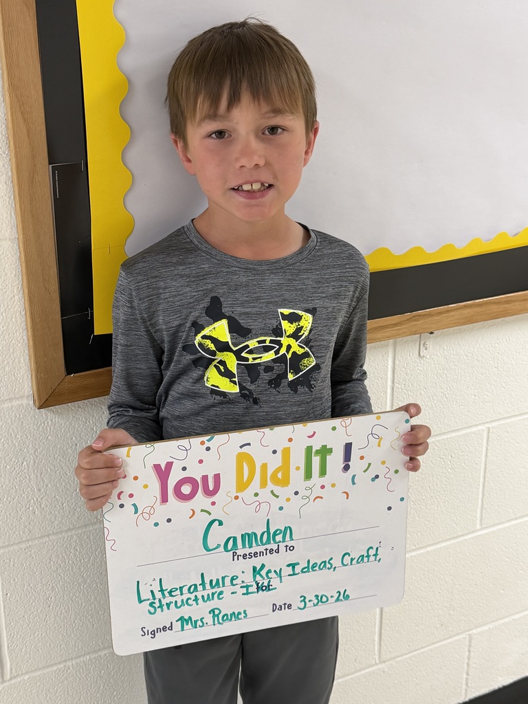 Child holding celebration board.
