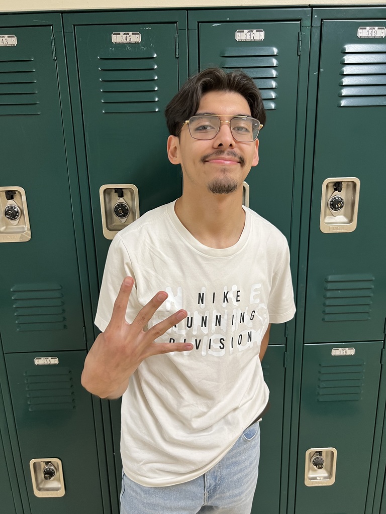 student heratio figueroa holding a number 4 up on his hands