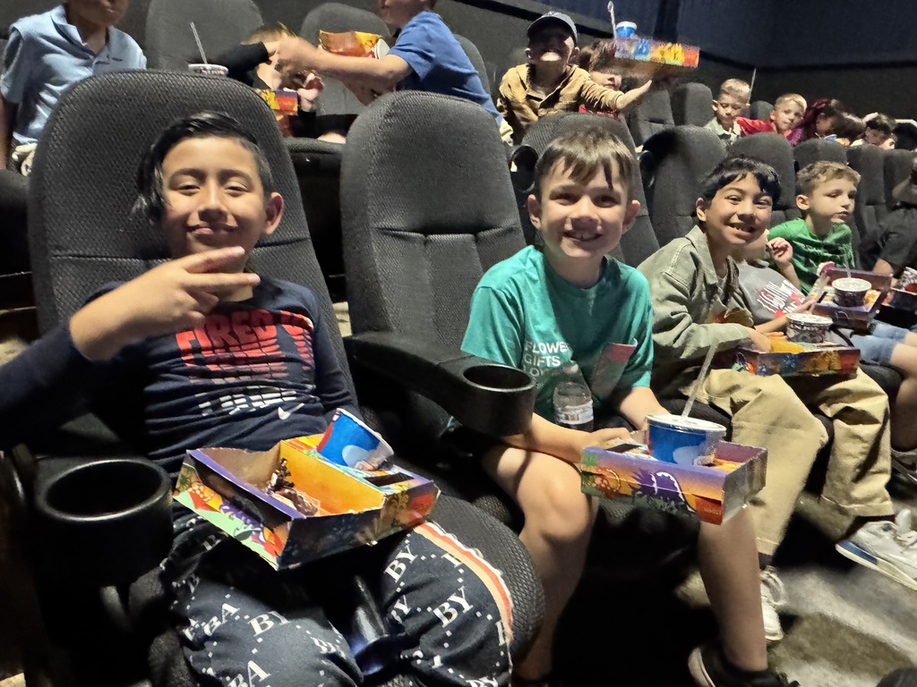 Large group of happy children at a movie theater.