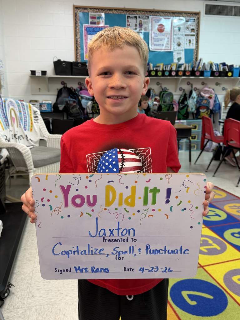 smiling child holding a celebration board