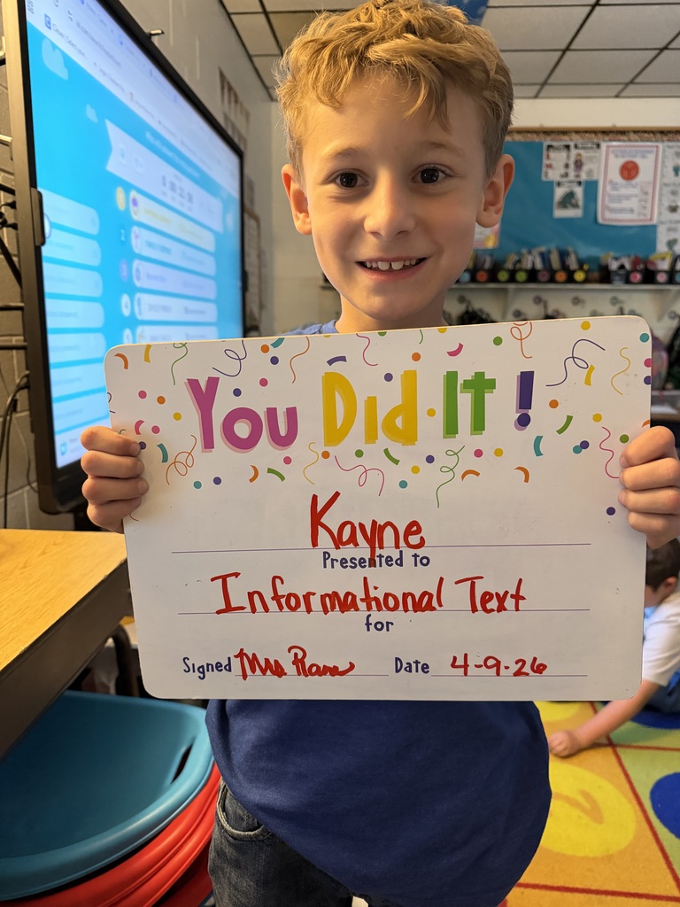 smiling child holding a celebration board