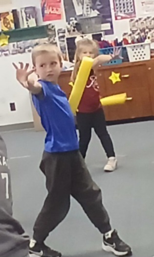 group of students practicing their light saber skills in music.  Technique is used as a musical skill.