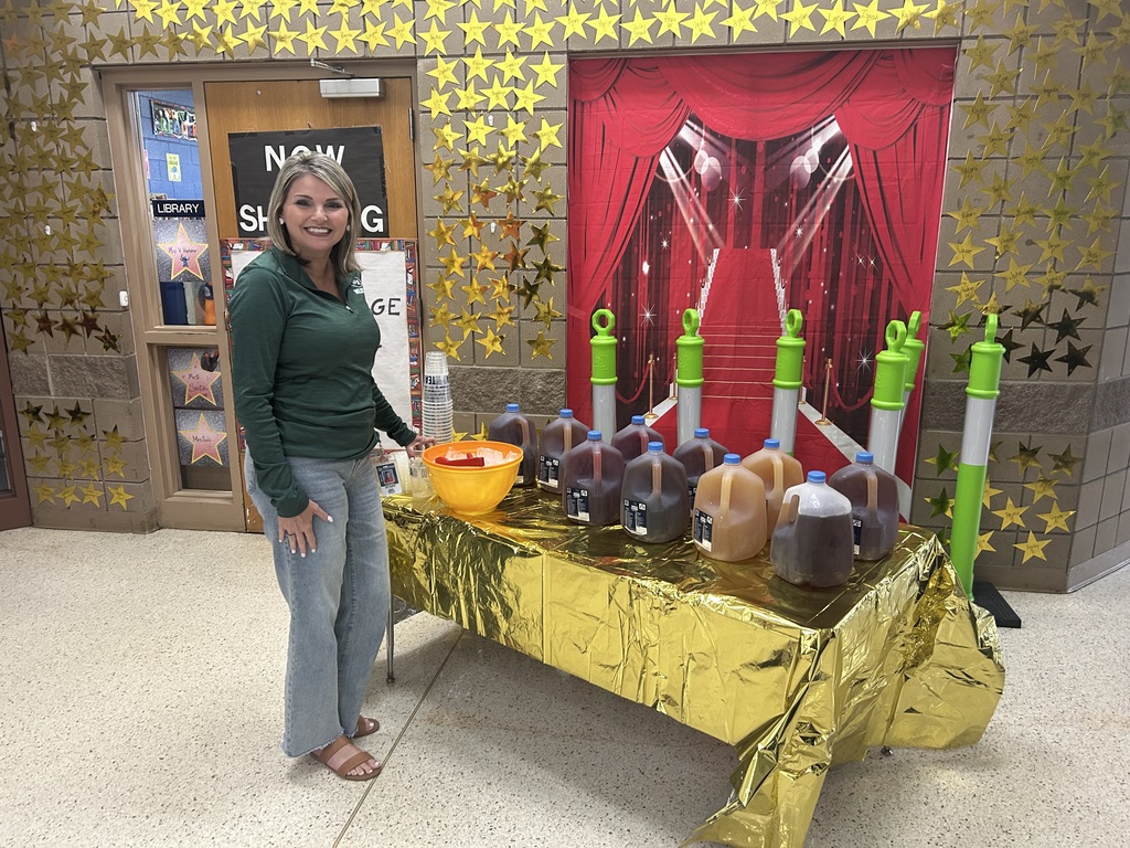 smiling lady with gallons of tea