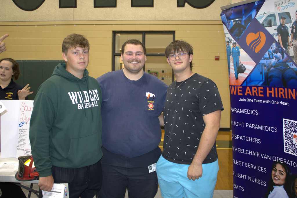 scurry fire department representatives with two students