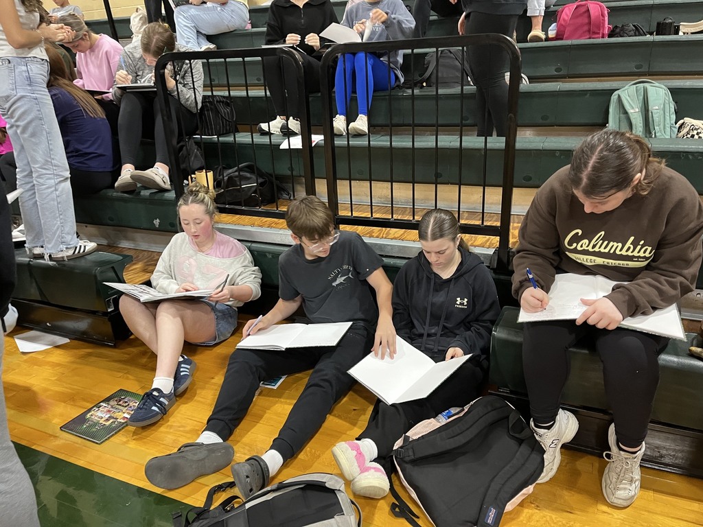group of students looking at their yearbooks