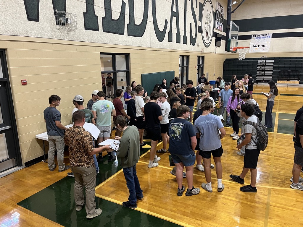 group of students waiting in line to pick up their yearbooks