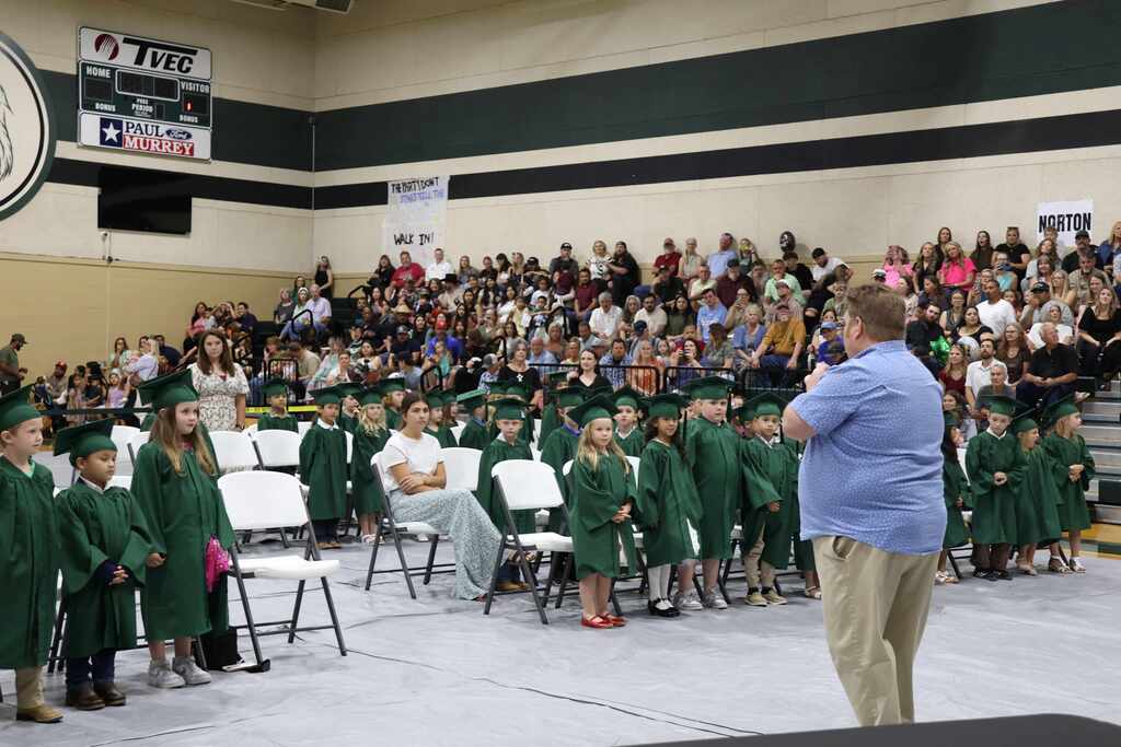 male music teacher and kindergarten students singing