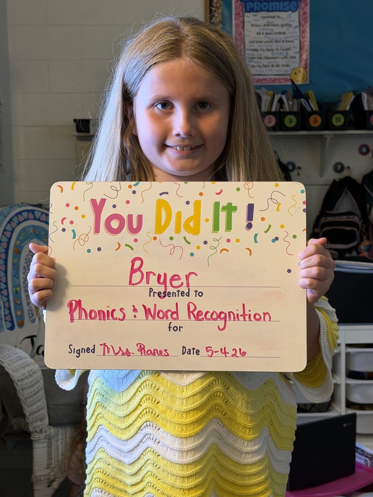smiling child holding highlighted accomplishment
