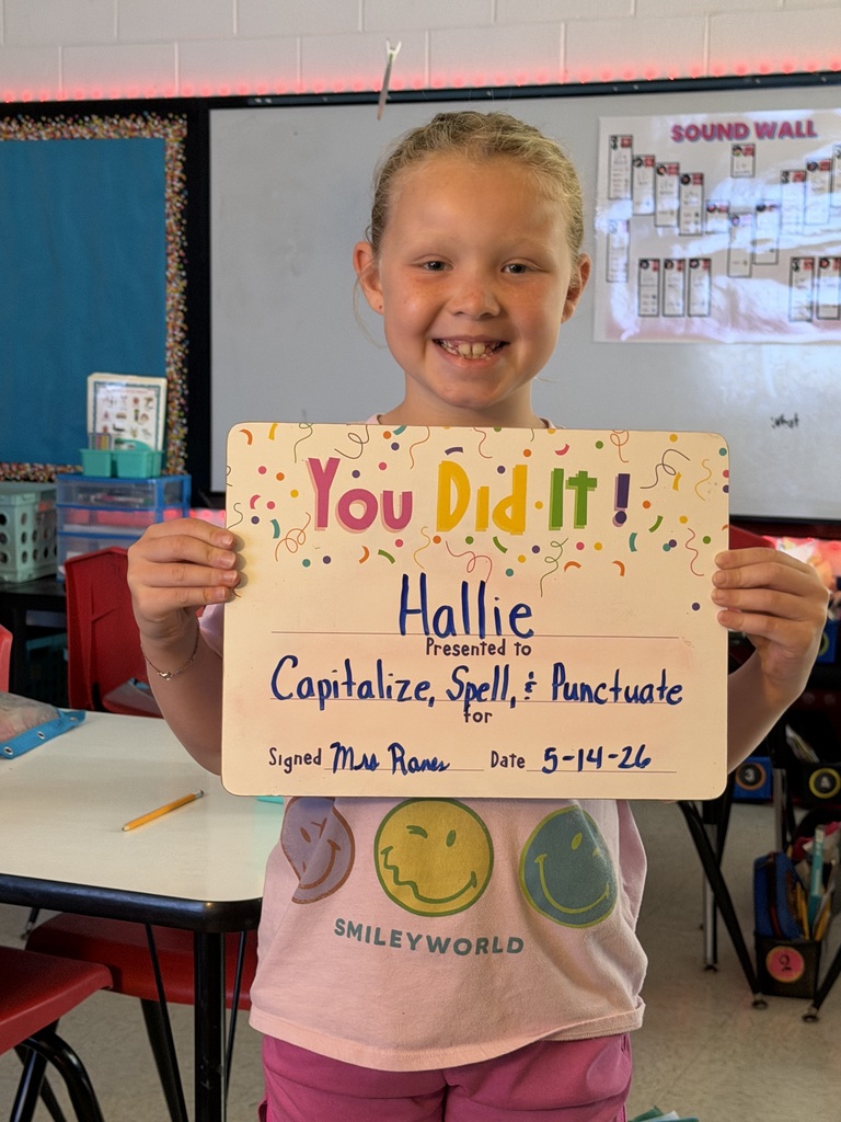 smiling child holding highlighted accomplishment