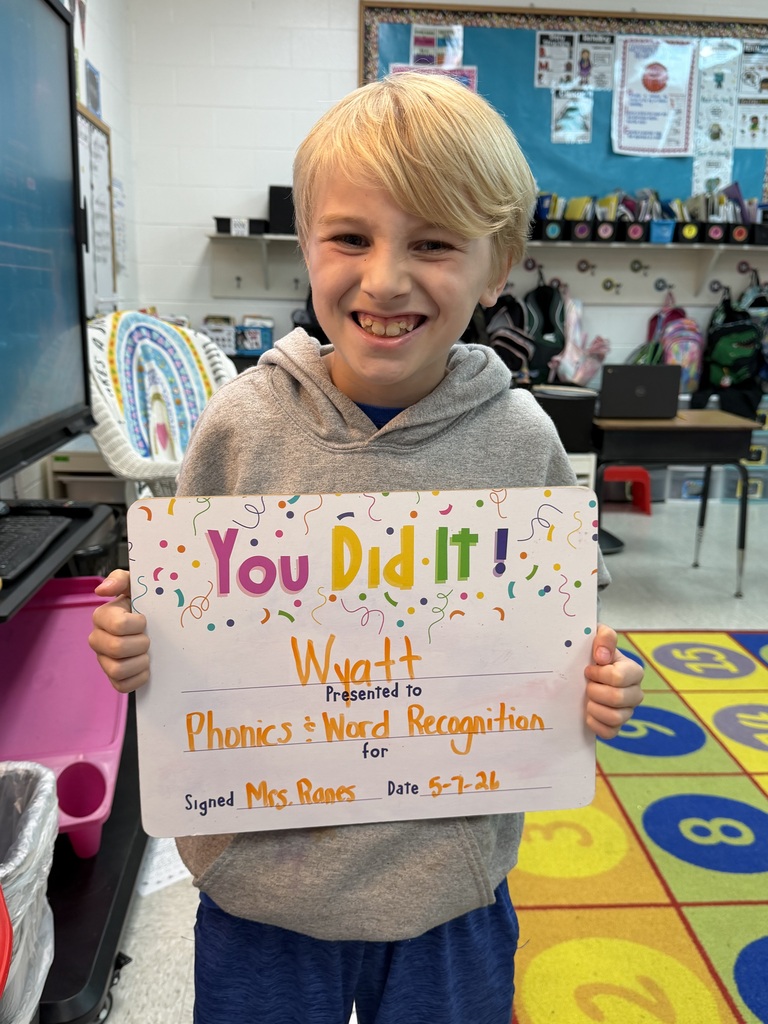 smiling child holding highlighted accomplishment