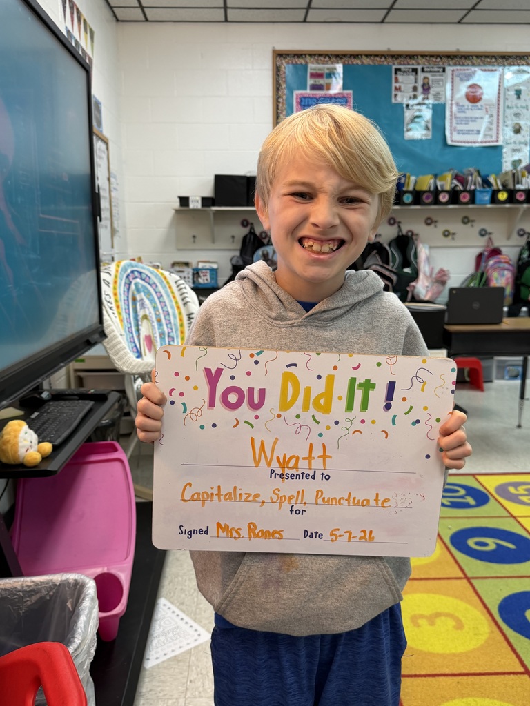 smiling child holding highlighted accomplishment