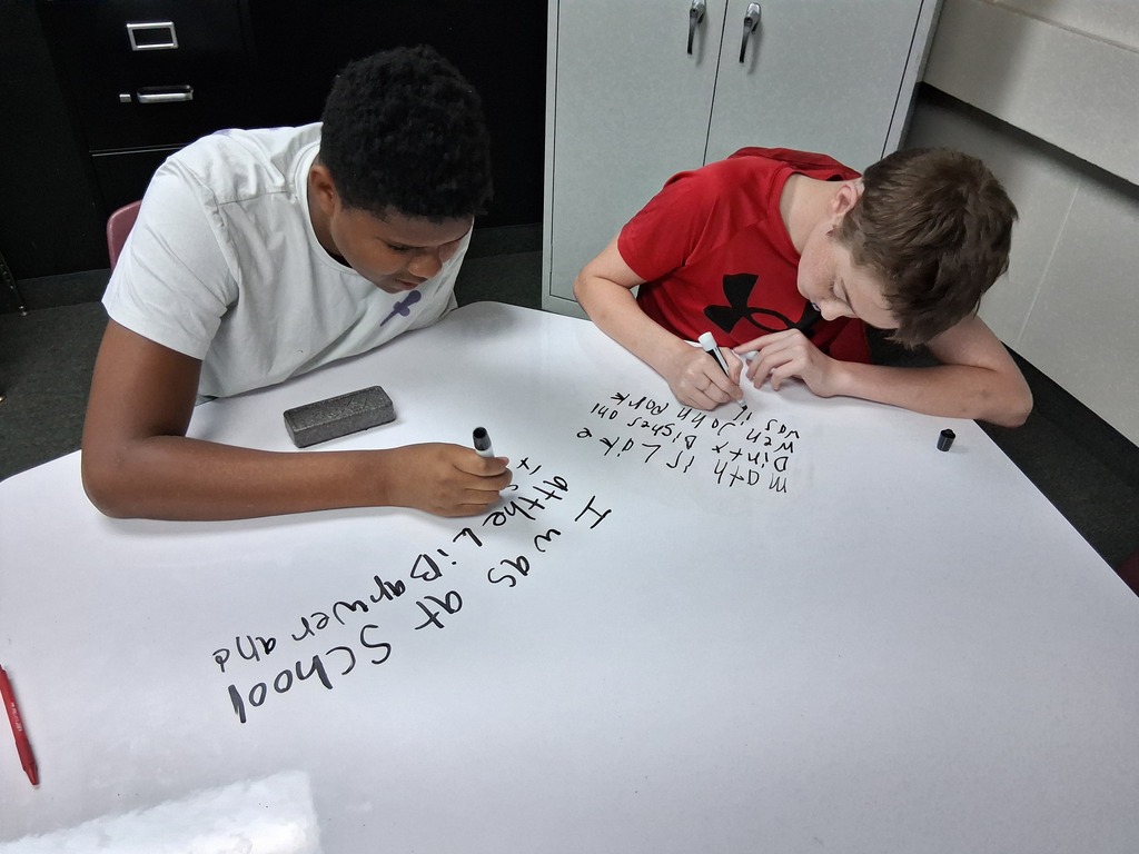 Students writing medals