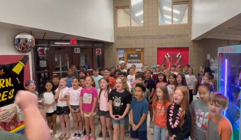 group of students sining the school song