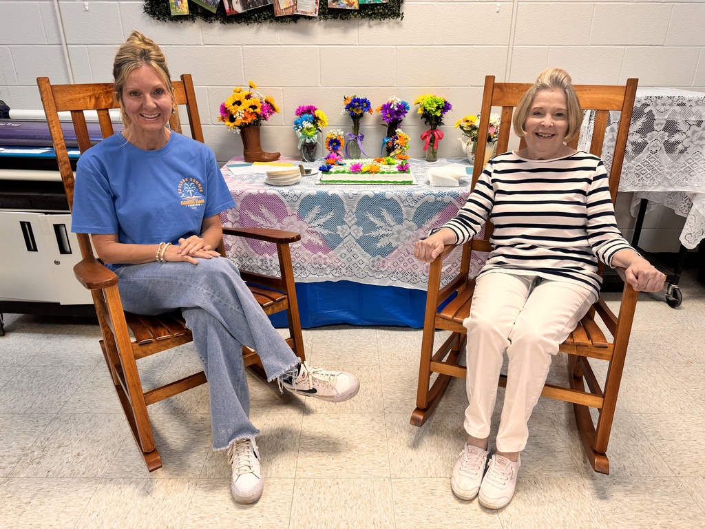 2 smiling ladies sitting in rocking chairs