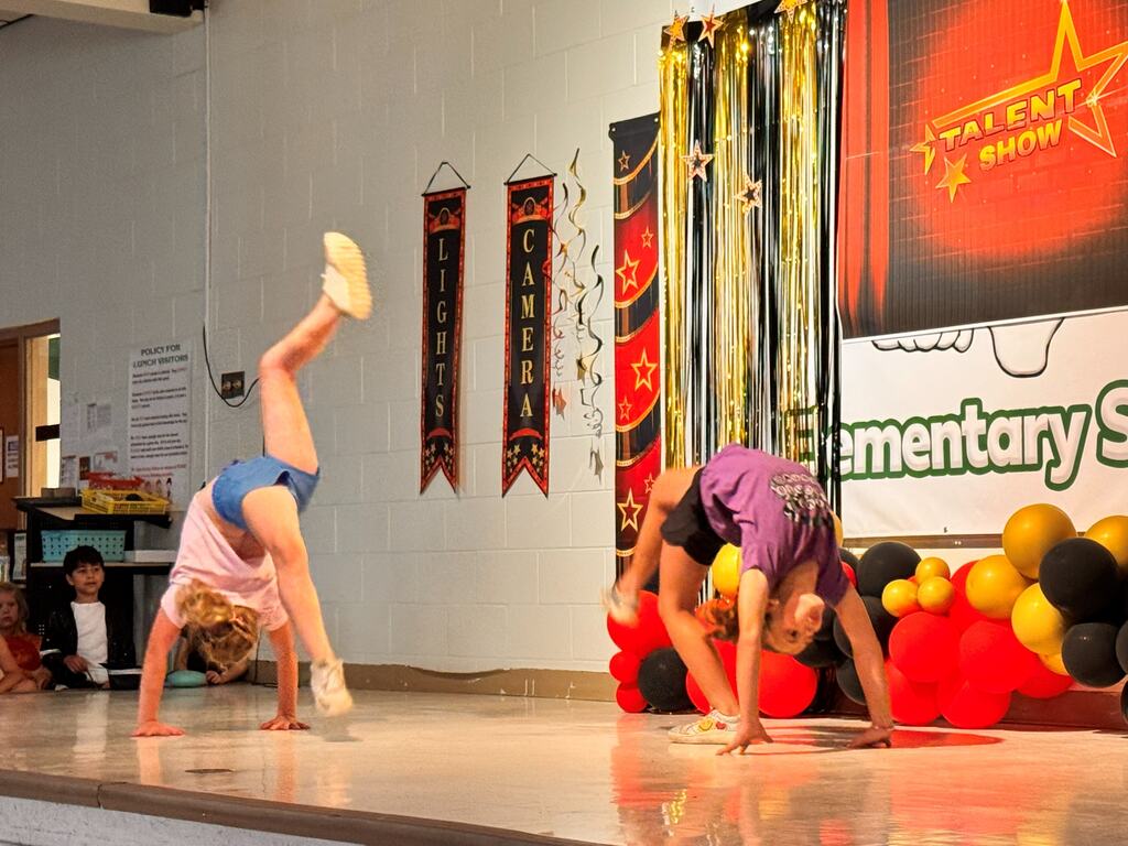 two female students performing backbend flip flops