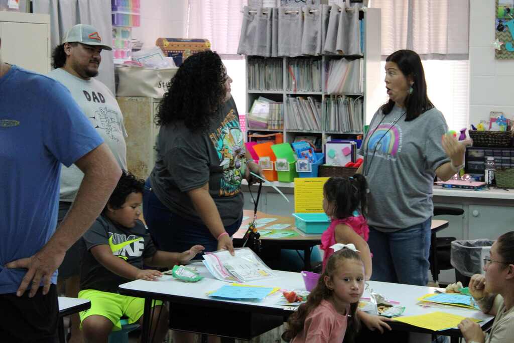 teacher and new students and parents at meet the teacher