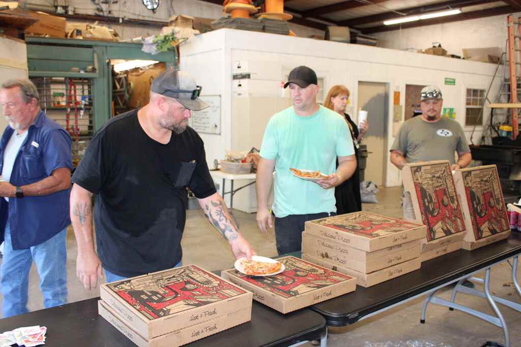 group picture of maintenance department eating lunch