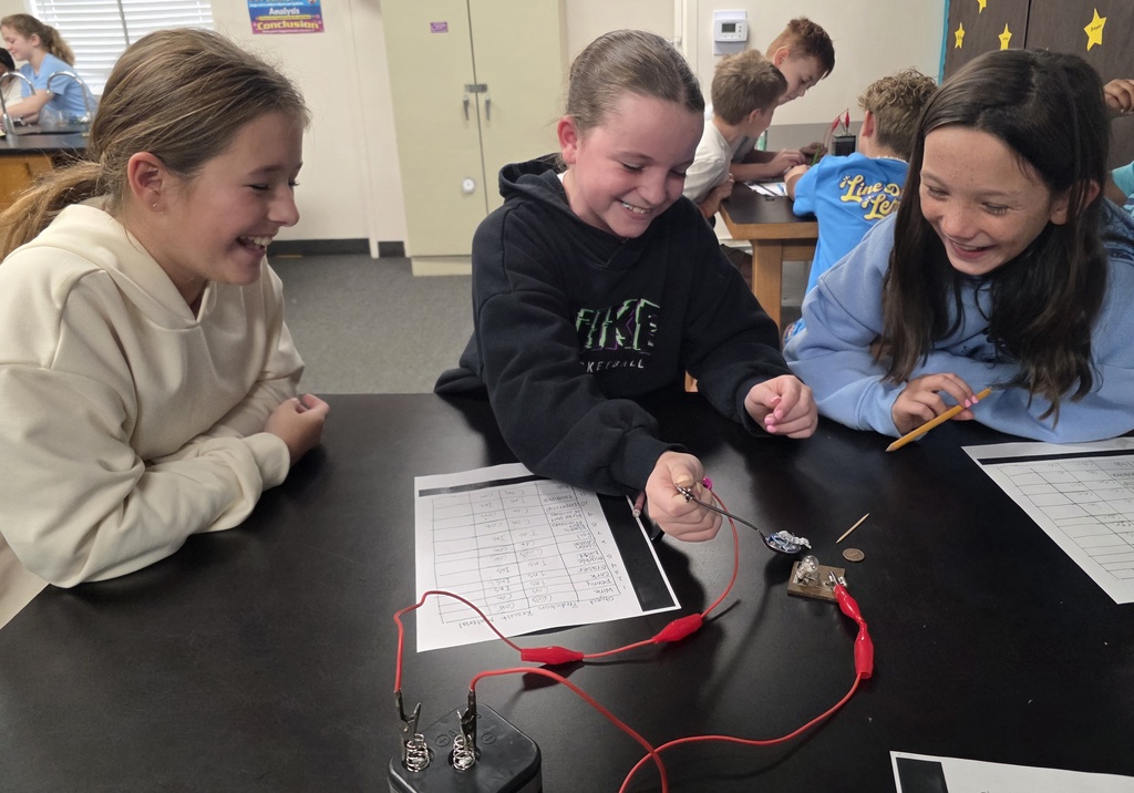 students completing a science experiement