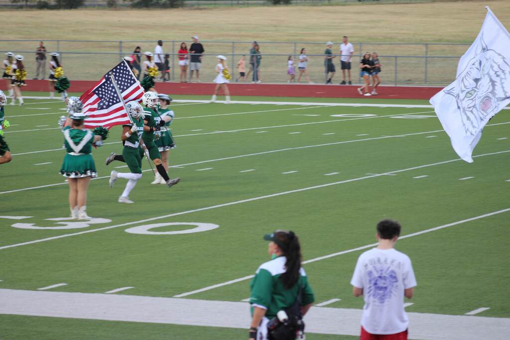 athletes running in with flags